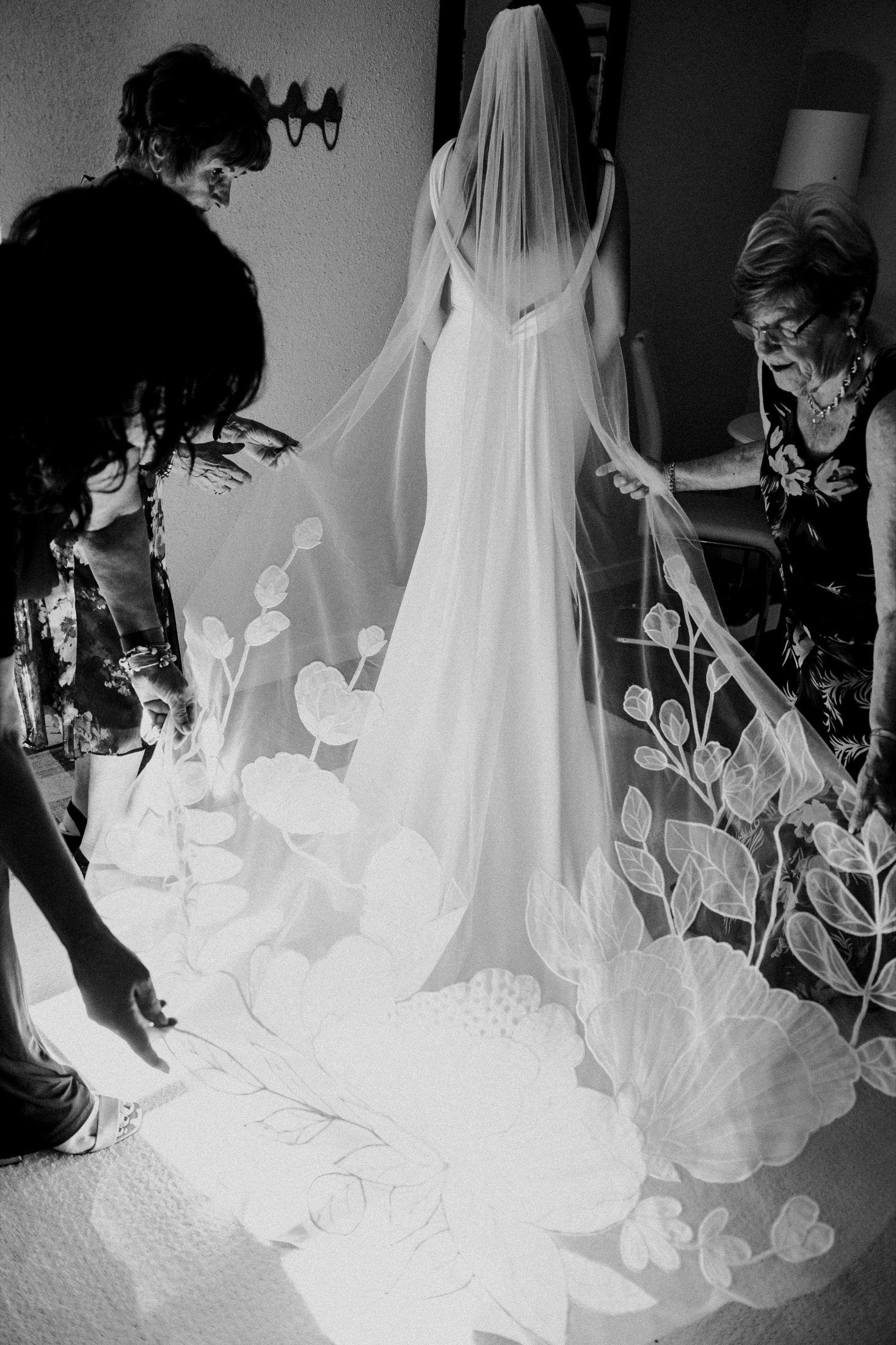 Black and white documentary wedding photograph with veil