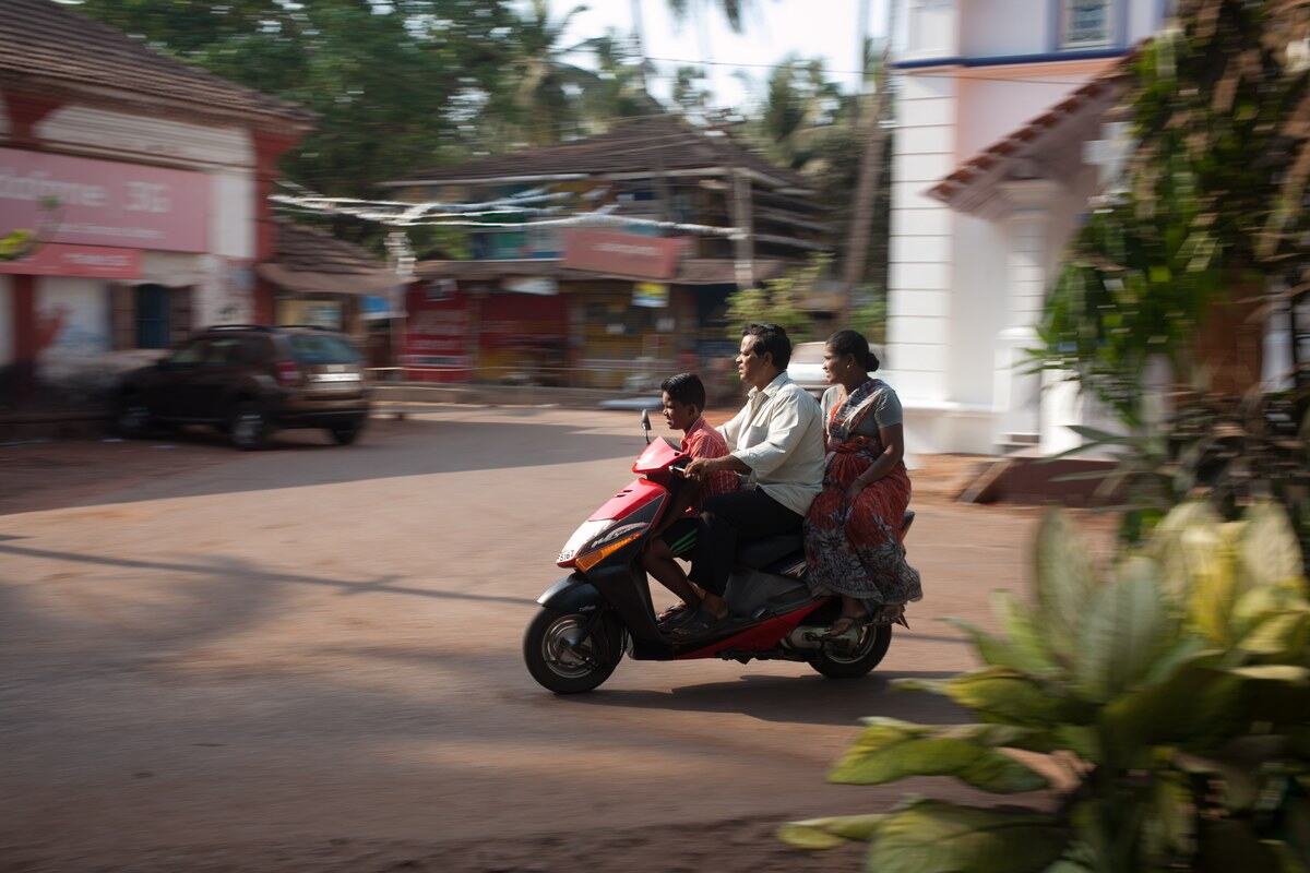 A family rides a scooter through Mysore, also known as Mysuru, India.