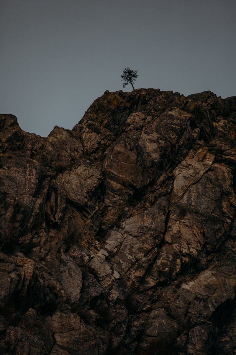 Dark Osoyoos rock and sky in a warm desert-edge study.