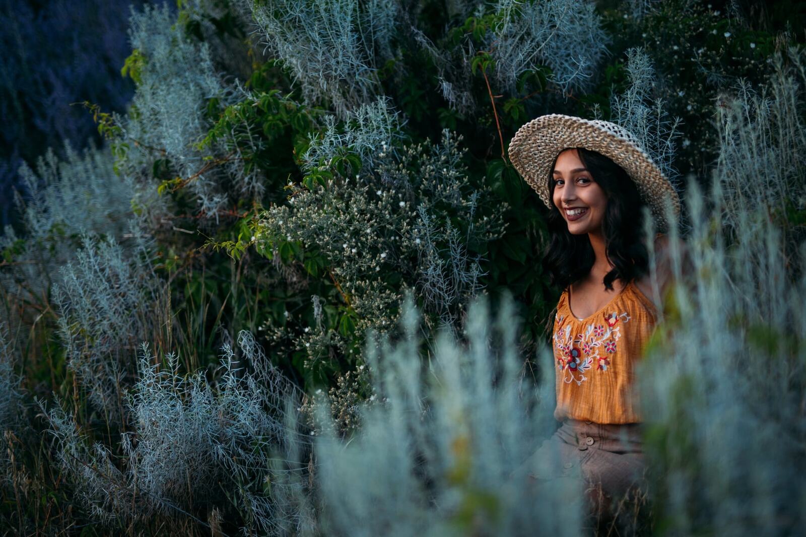 Angelica in Garden Light story frame 20: Mirror play, garden colour, straw hat and reflective frames with a quieter kind of romance.