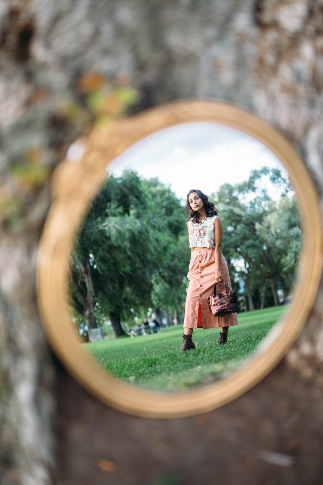 Angelica in Garden Light story frame 2: Mirror play, garden colour, straw hat and reflective frames with a quieter kind of romance.