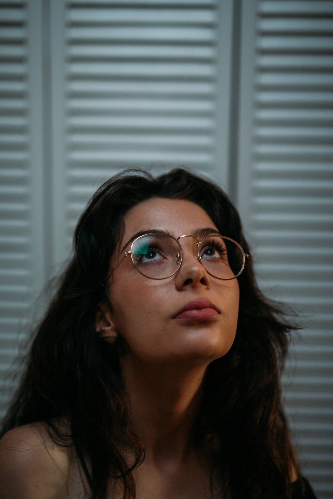 Mel in Reeds and Warm Dusk story frame 15: Bubbles, lake edge, reeds, glasses and dusk colour from a playful portrait story.