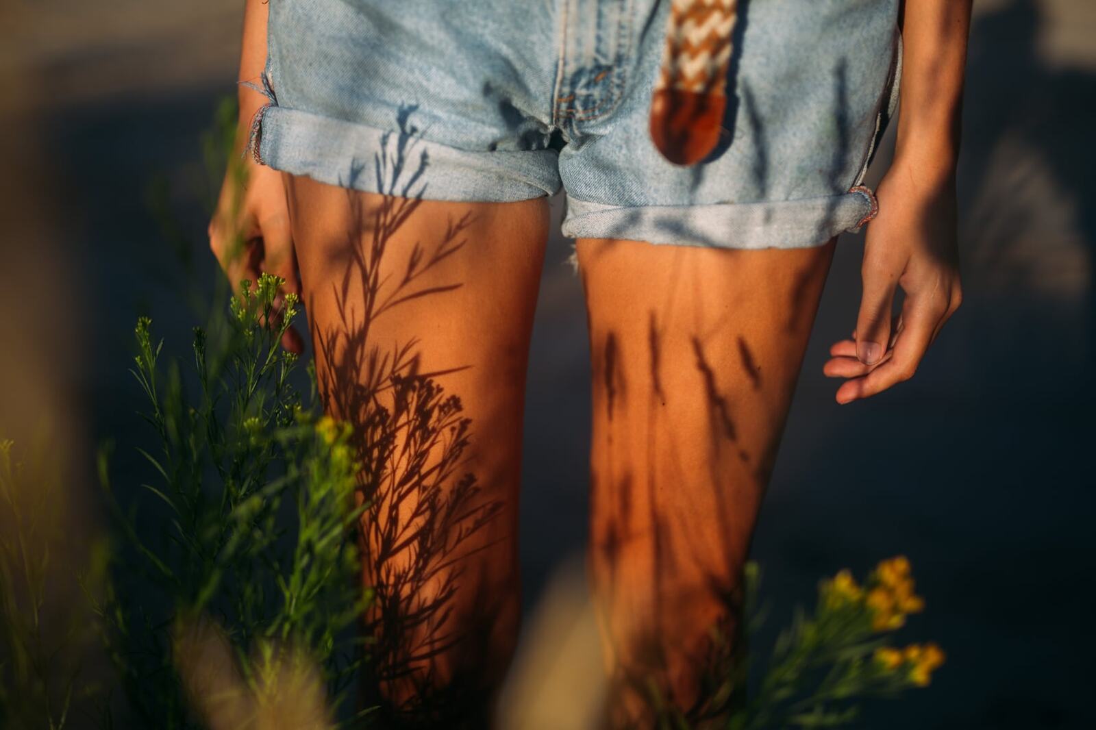 Mo in the Reeds story frame 1: Green shadow, tall grass, body paint and a charged quiet that stays grounded in portrait atmosphere.
