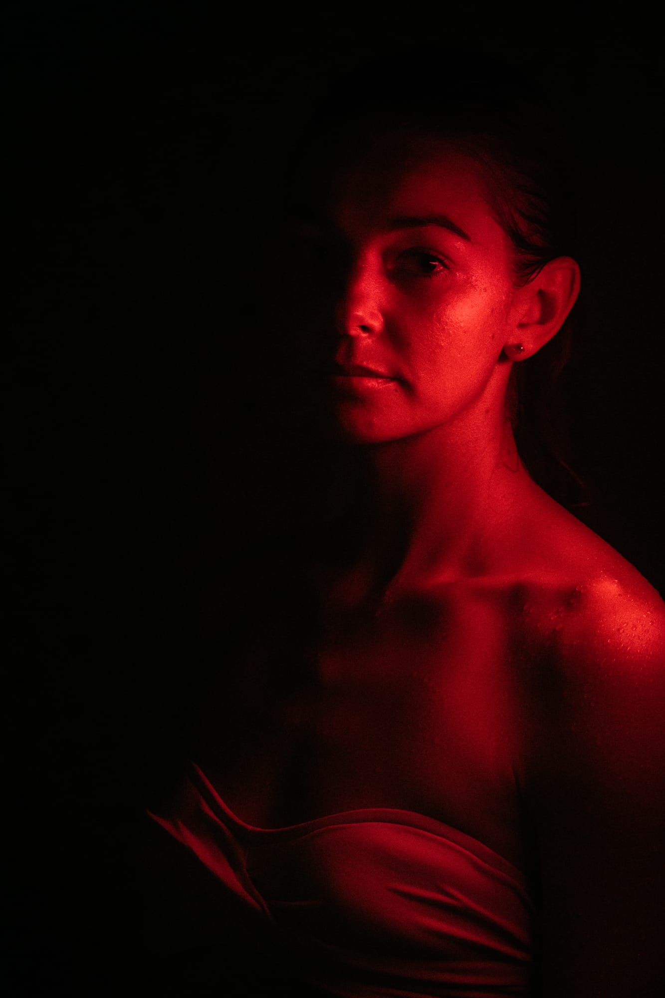 Angela at Float Space portraits story frame 5: A Float Space portrait set that moves from clean wellness headshots into red low-key portraits, skin, shadow and close detail.