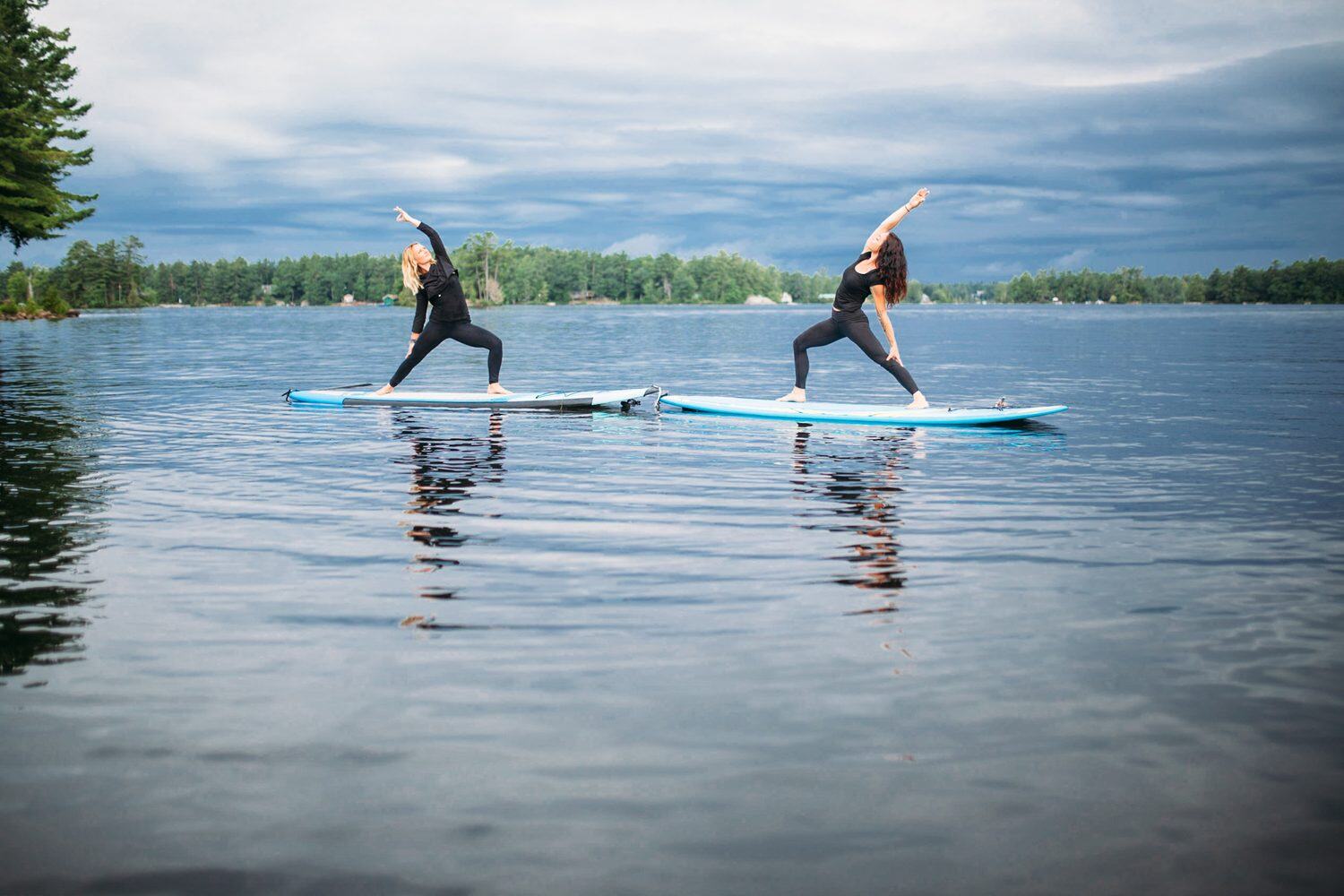 Ash and Jill, SUP Yoga corporate story frame 3: Corporate lifestyle photography for Ash and Jill on stand-up paddleboards, with yoga movement, instructor portraits and lake-based imagery for a wellness business.
