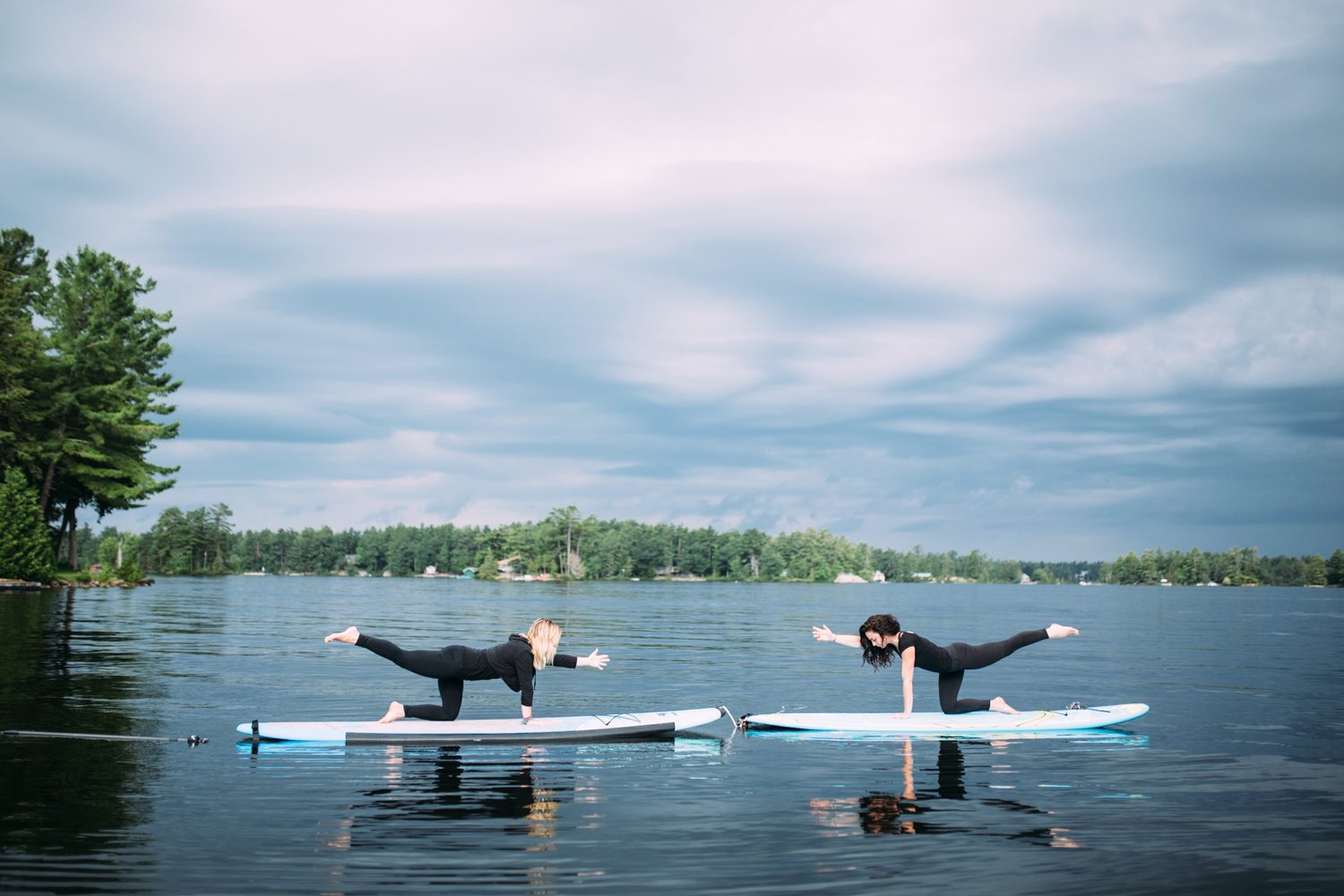 Ash and Jill, SUP Yoga corporate story frame 35: Corporate lifestyle photography for Ash and Jill on stand-up paddleboards, with yoga movement, instructor portraits and lake-based imagery for a wellness business.