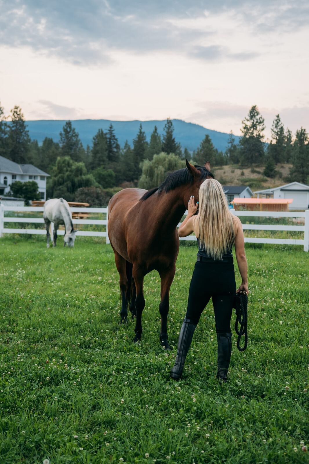 Ashton at the Ranch portraits story frame 16: Ranch portraits for Ashton in Kelowna, with horses, open pasture, quiet country styling and Okanagan light shaped into a grounded portrait story.