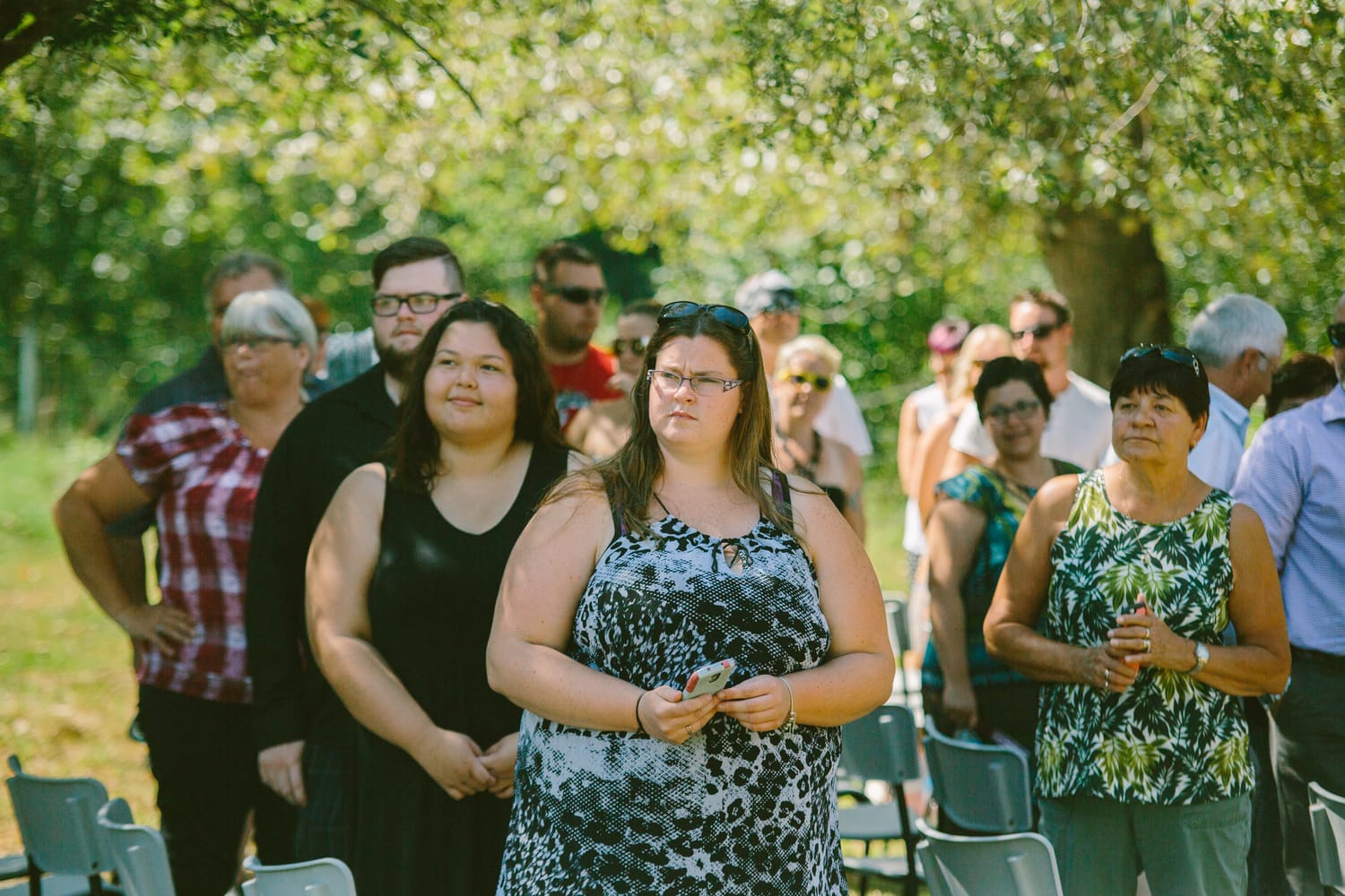 Barbara and Ryan weddings story frame 9: A Salmon Arm wedding near Mount Ida, moving from a private yard to Marine Peace Park and wharf portraits, with the groom's trucking life part of the story..