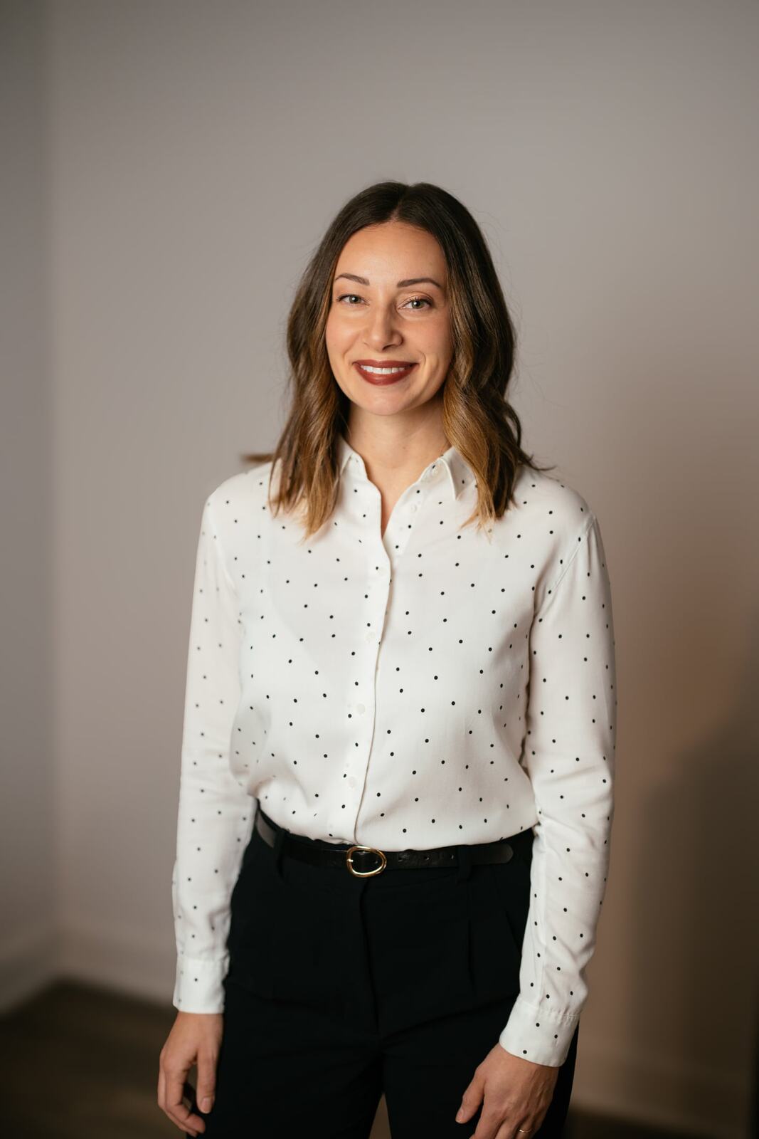 Beth in a warm full-length studio headshot