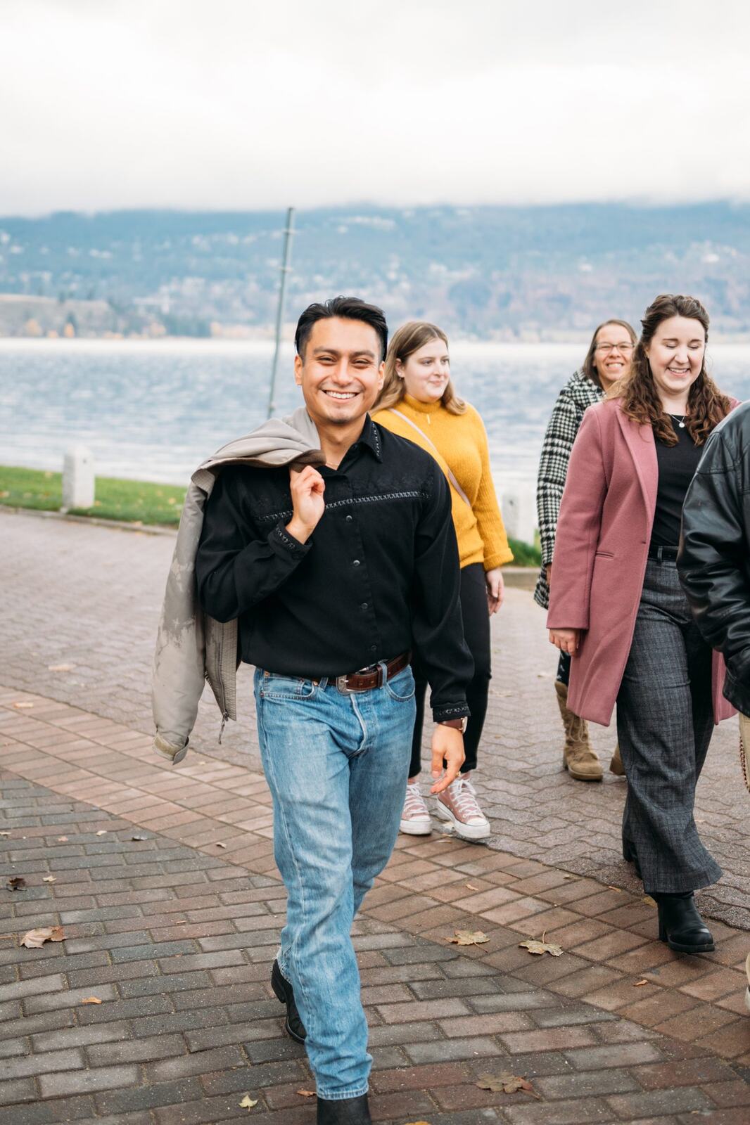 BrainTrust Canada Waterfront corporate story frame 30: Waterfront team and brand portraits for BrainTrust Canada in Kelowna, built around group photos, walking images and approachable nonprofit profile photography..