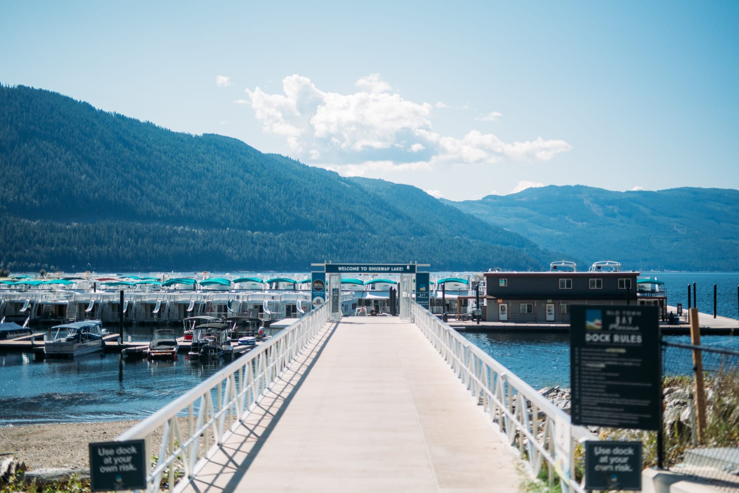 Carmel and Chris weddings story frame 1: A Sicamous and Shuswap Lake houseboat wedding that moved from water to beach, with friend-community overlap and a relaxed lakeside feeling..