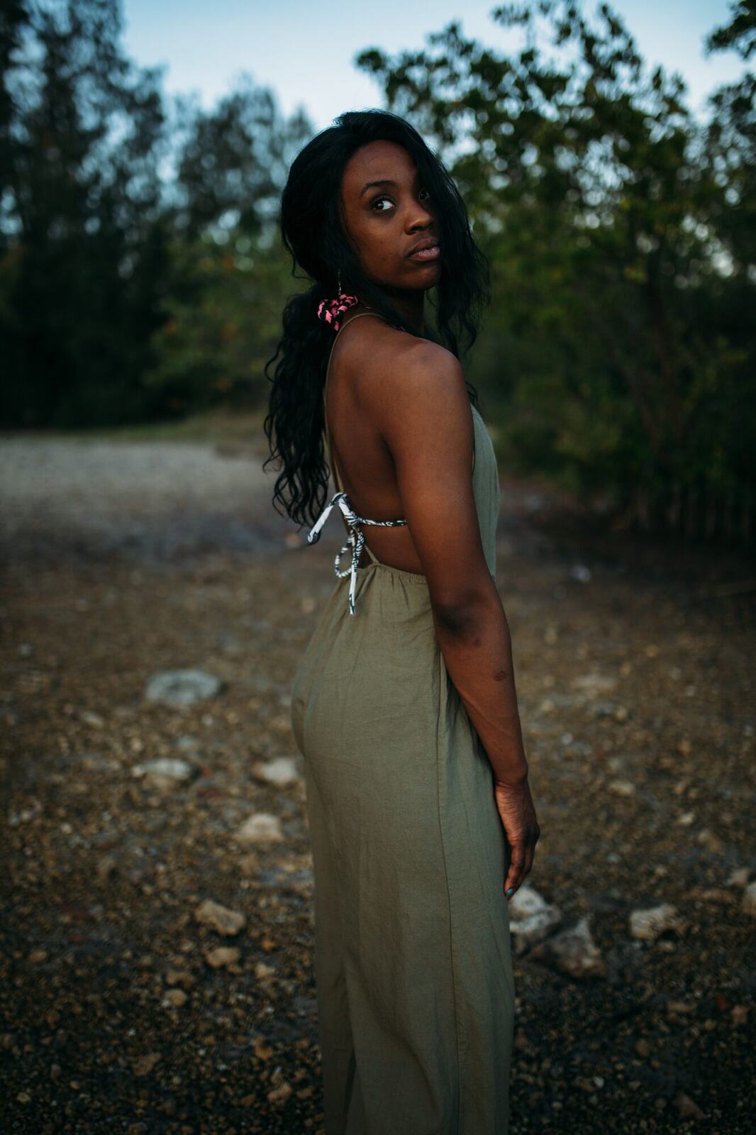 Dee-J in Miami portraits story frame 32: Two days with Dee-J in Miami, moving from a bright poolside portrait story to a second pool sequence and green-dress portraits along the riverbank.