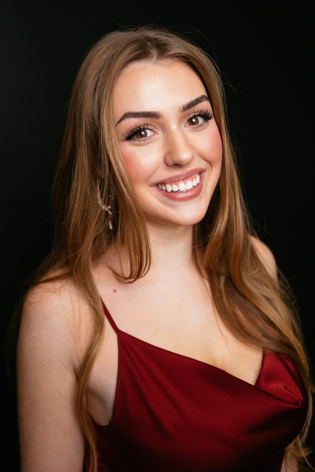 Bright studio headshot of Elena in wardrobe look 5