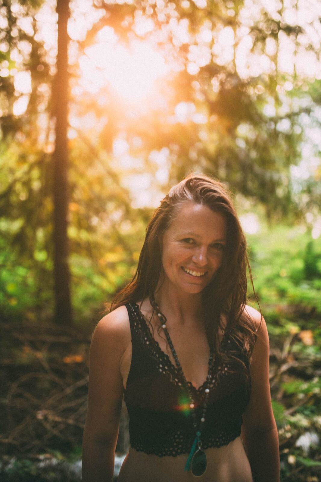 Erin at Mara Lake portraits story frame 2: Mara Lake portraits for Erin with driftwood, warm water, tattoo detail and soft evening light across the Shuswap shoreline.