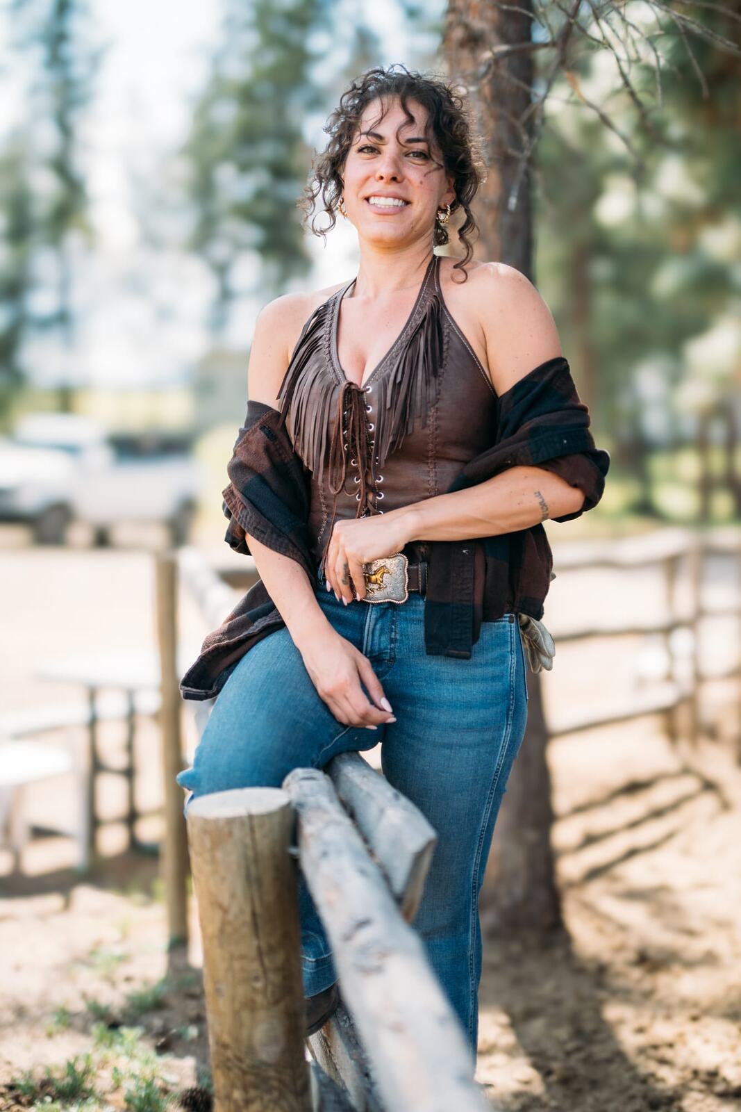 Giuliana at LoveReins portraits story frame 6: Equestrian portrait session at Love Reins Ranch in Lake Country, BC, with Giuliana, horses, white-dress portraits, Western cowgirl styling, ranch fencing, riding frames and warm Okanagan light..