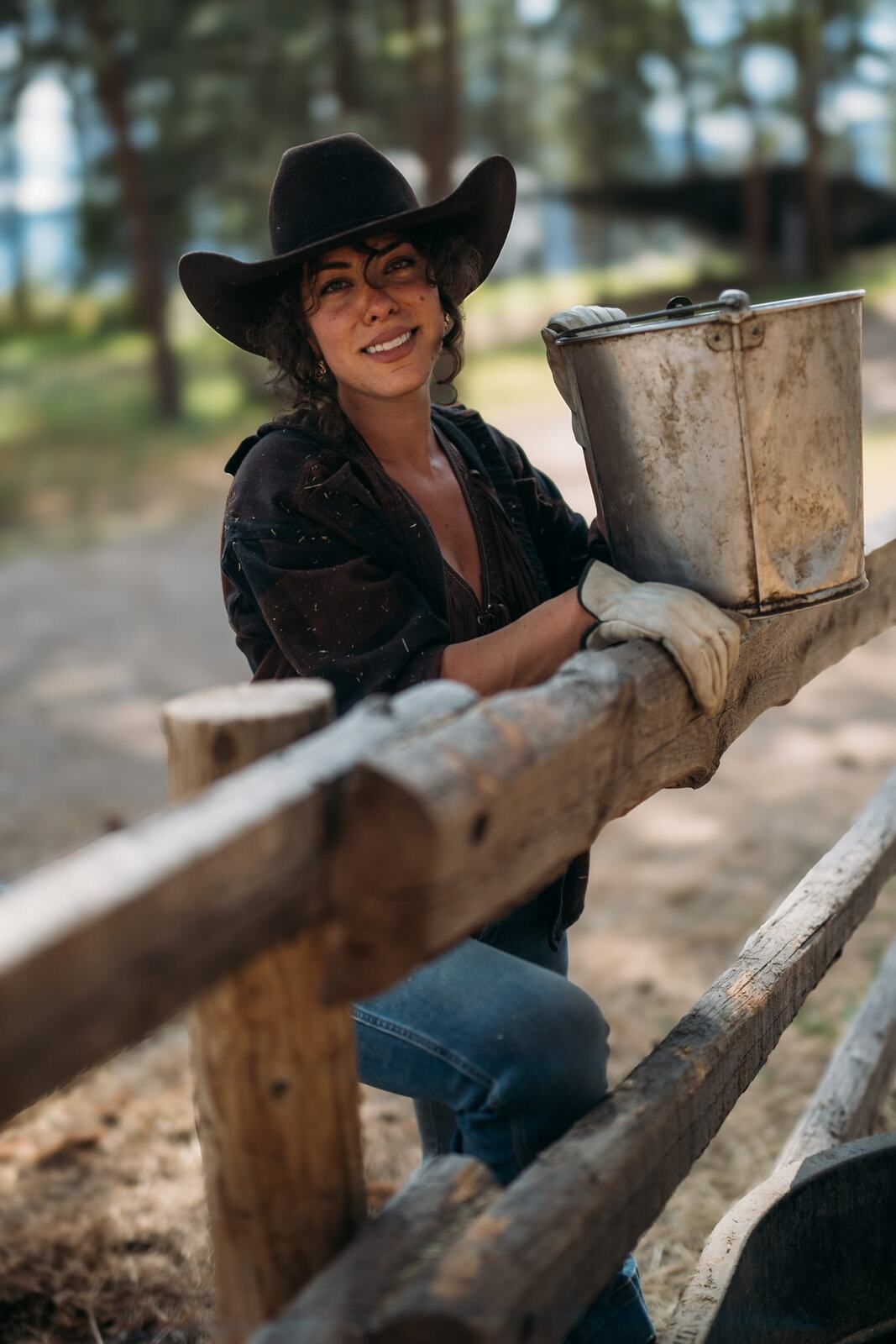 Giuliana at LoveReins portraits story frame 19: Equestrian portrait session at Love Reins Ranch in Lake Country, BC, with Giuliana, horses, white-dress portraits, Western cowgirl styling, ranch fencing, riding frames and warm Okanagan light..