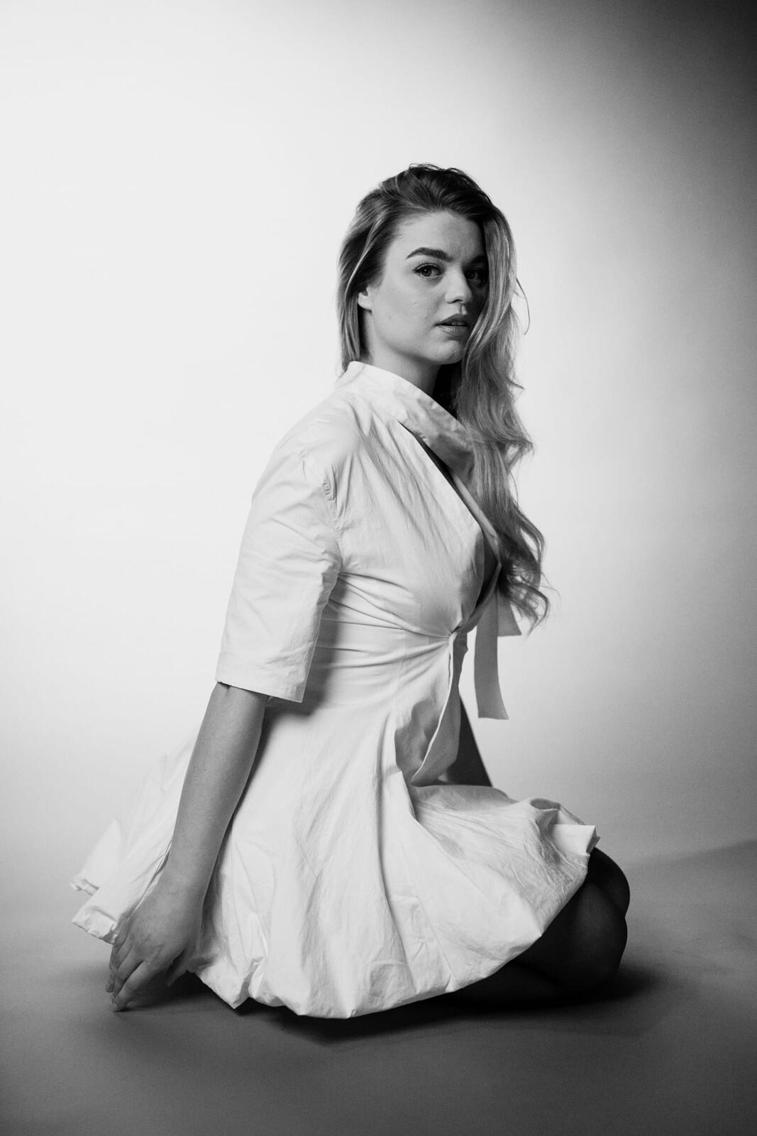 Hannah K in Black and White portraits story frame 34: A black-and-white studio portrait study with clean wardrobe shifts, close face work and controlled light.
