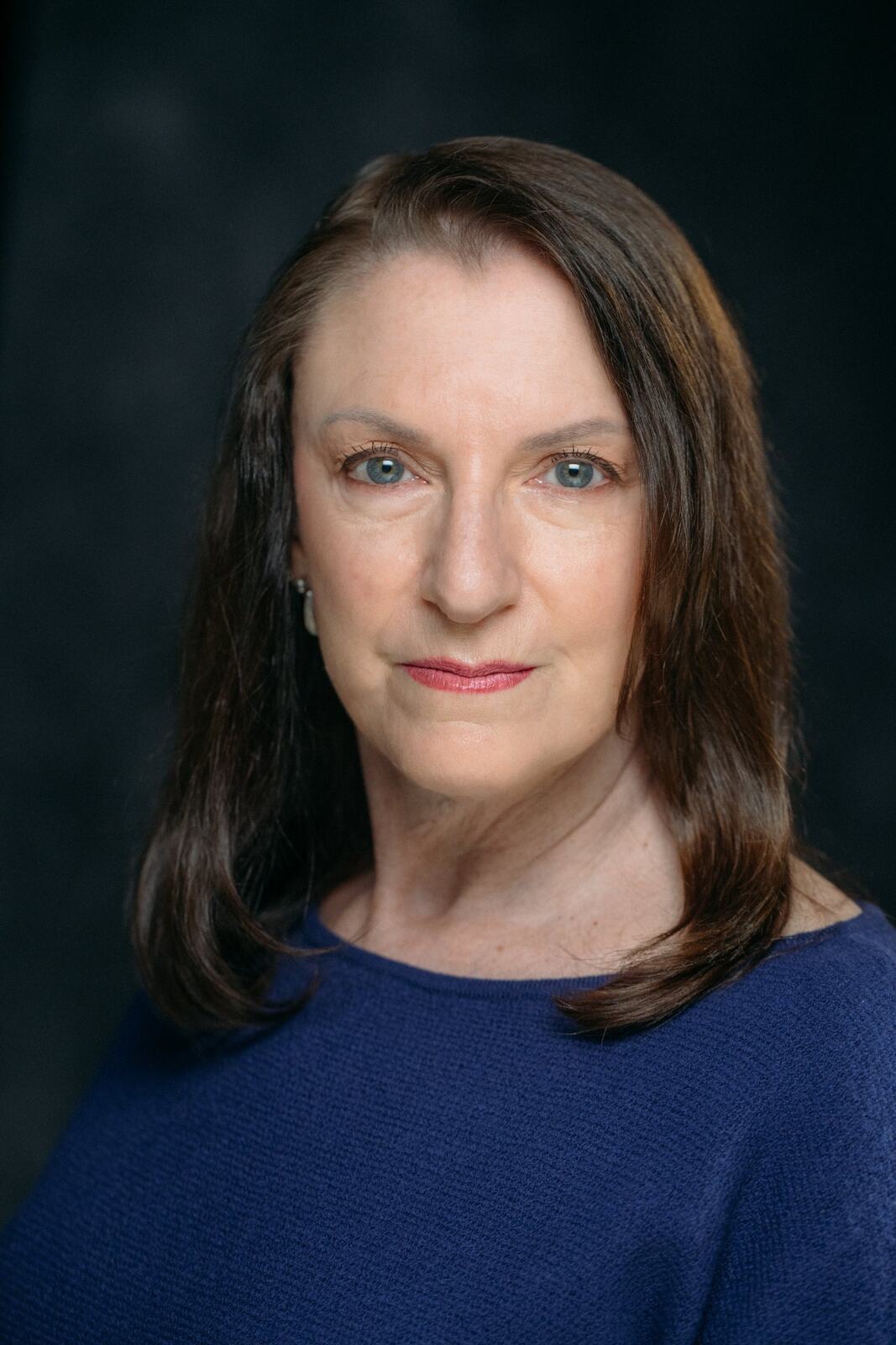 Marie in a blue knit top for a direct Headshot Day portrait