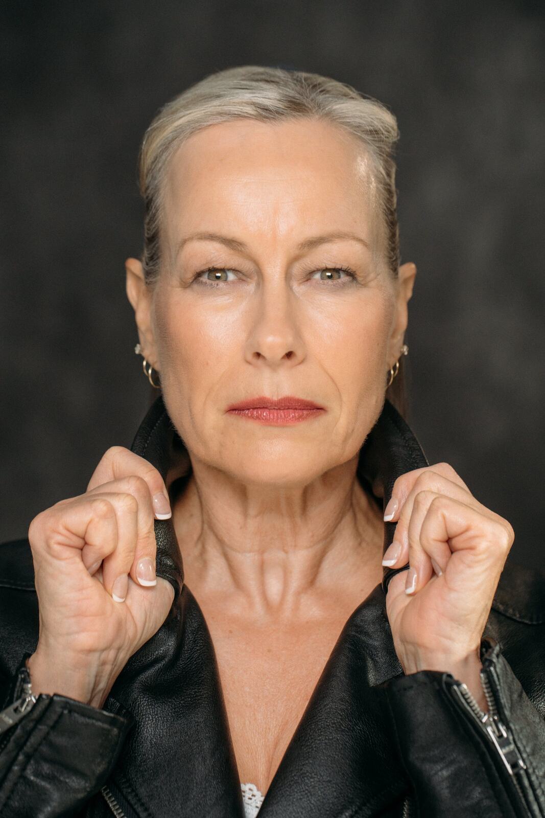 Shaye in a leather jacket with her hands near the collar