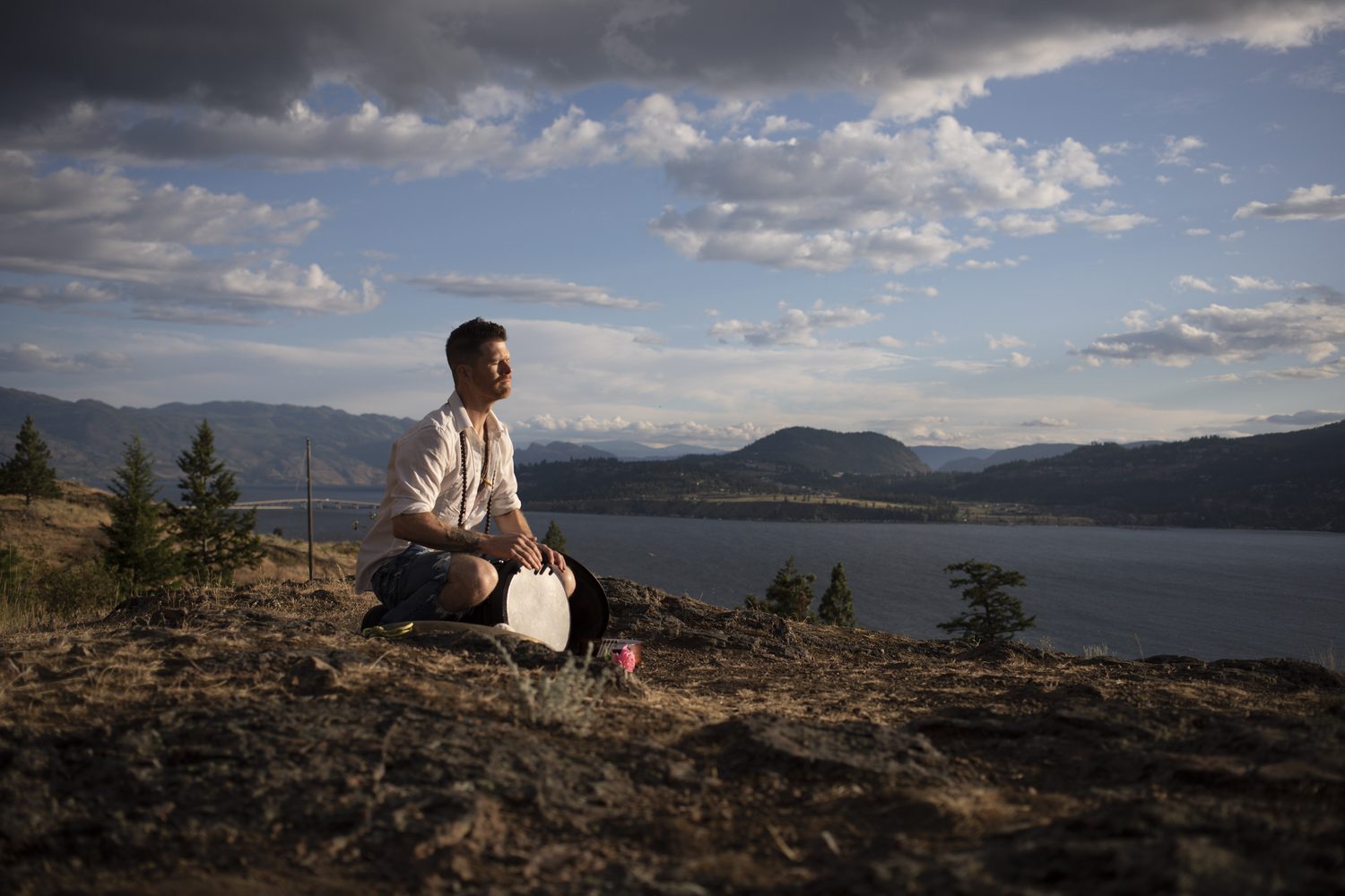 A quiet side-profile portrait of Jacob beside the handpan.