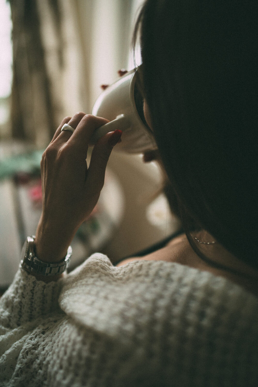 Jasmin by the Window portrait story frame 16: Window-light portraits with Jasmin beside a small table, tea and winter greenery in Kelowna, British Columbia.