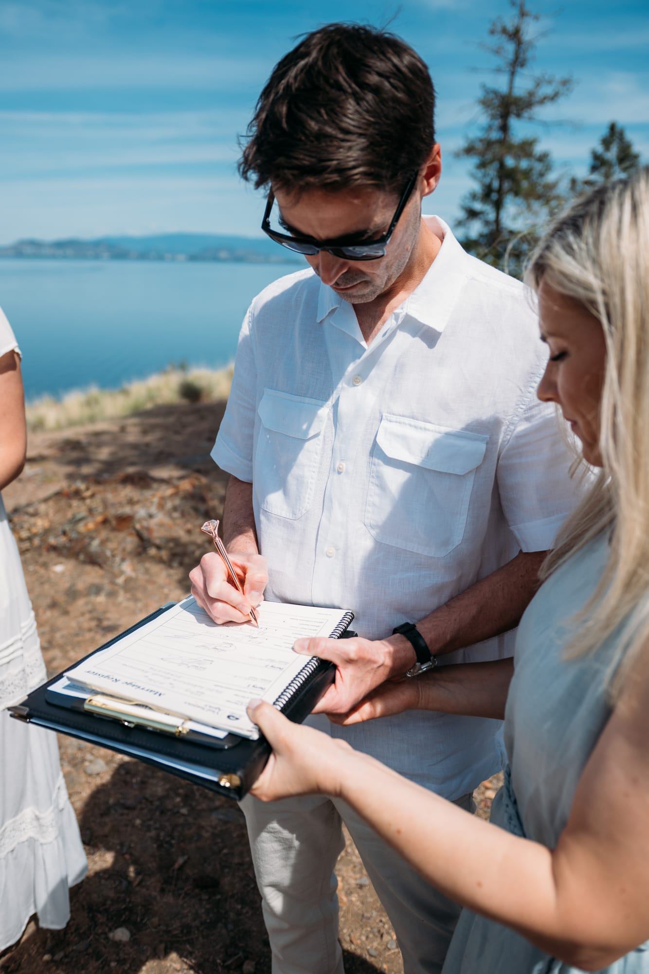 Kristina and Mark weddings story frame 12: A Bertram Creek wedding in South Kelowna with Okanagan Lake light, film-friend history, family texture and Lithuanian food and planning details..