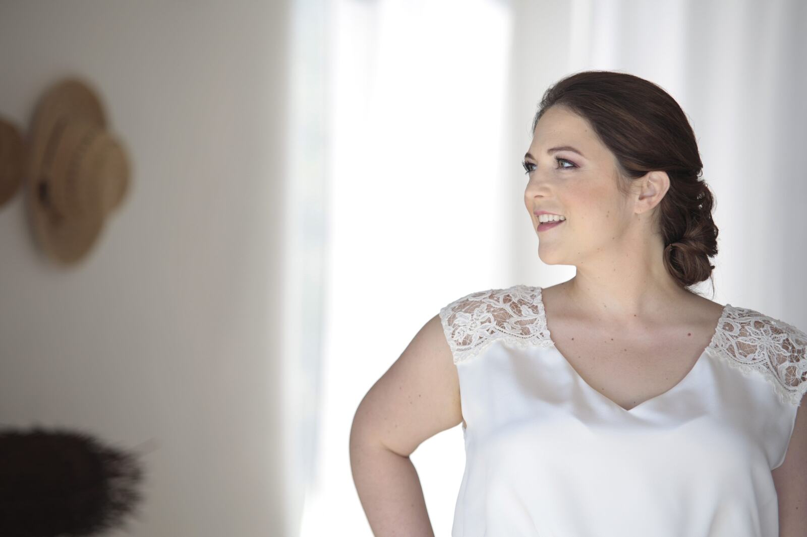 Kyra in soft window light before the ceremony