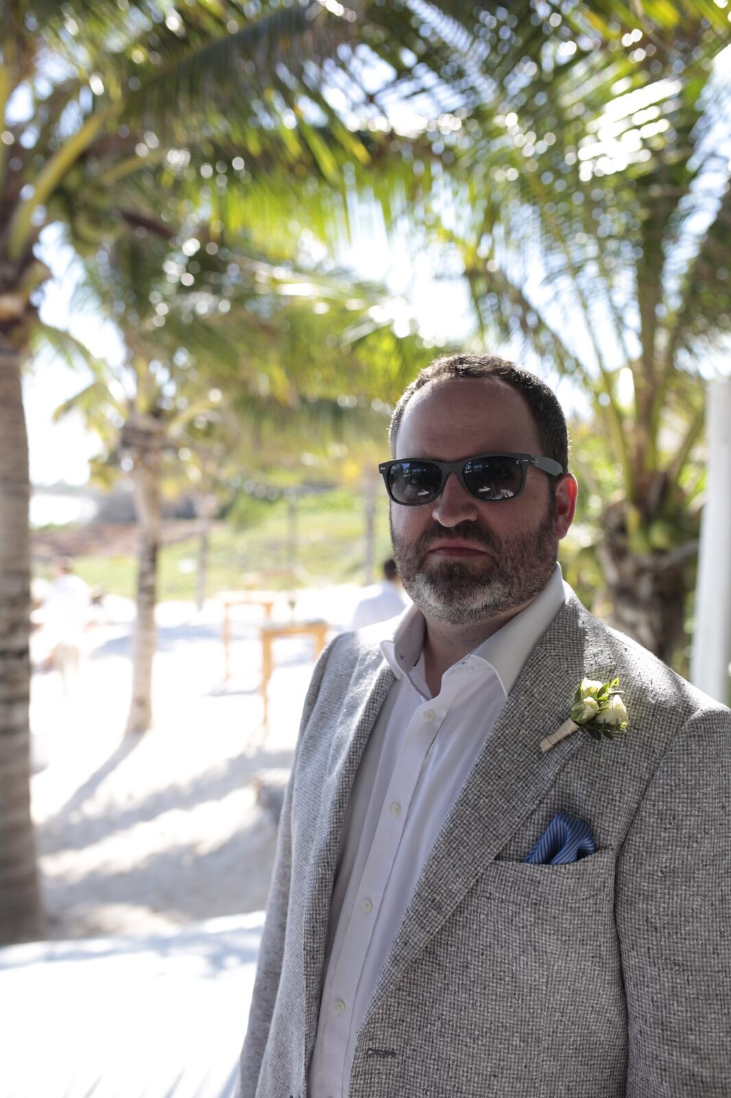 Portrait of Ted beneath the palms before the ceremony