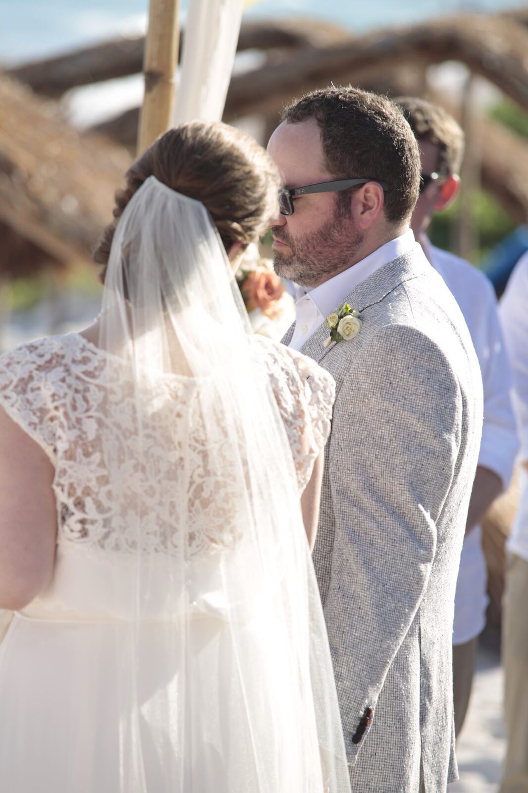 Kyra and Ted kissing during their beach ceremony