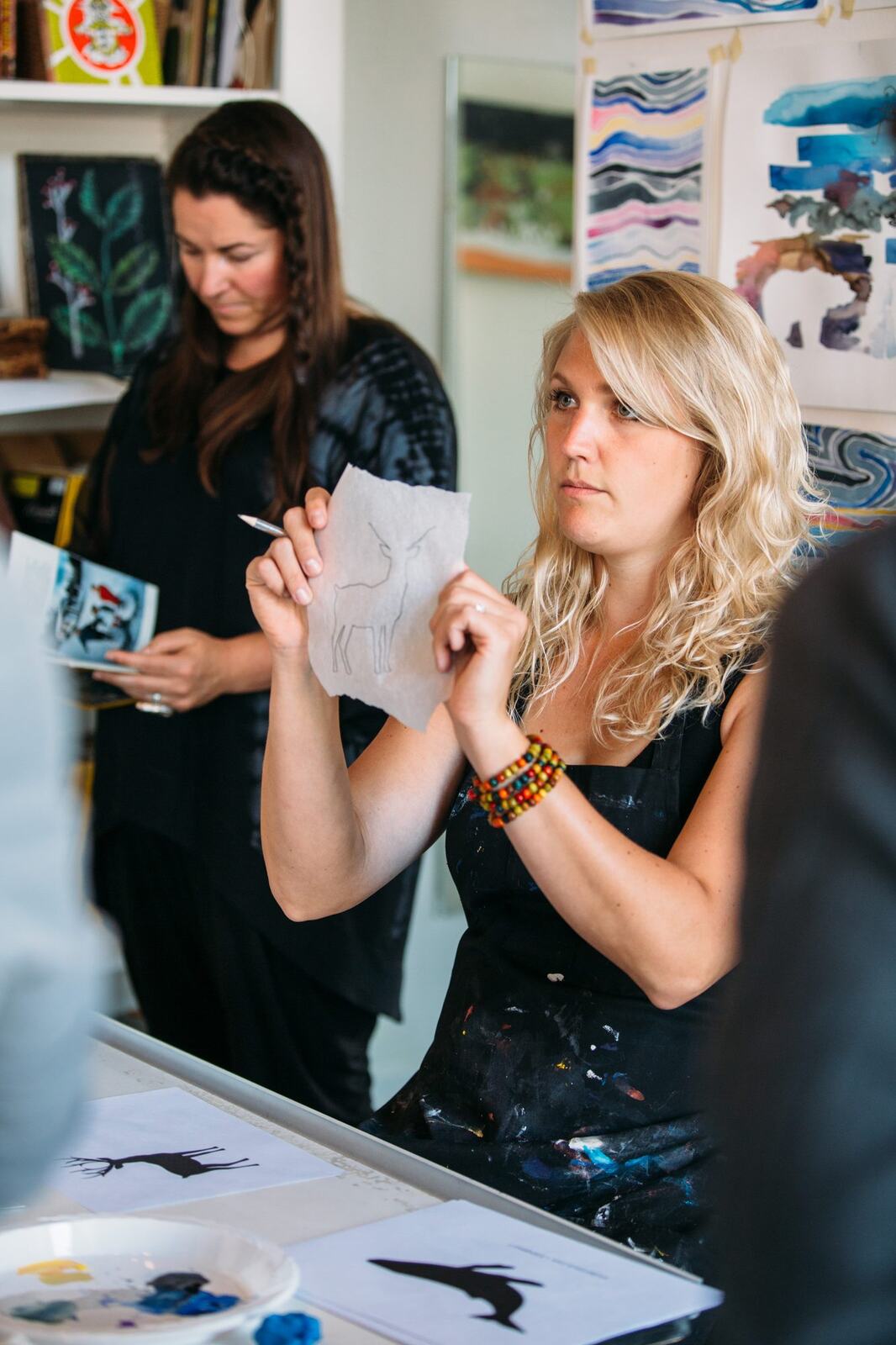 Sarah Lewke demonstrating a small technique while holding paper.