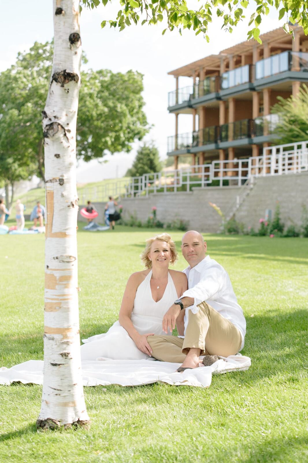 Leeanne and Kelly weddings story frame 6: A Watermark Beach Resort wedding in Osoyoos, built around lakefront context, grown-family connection and careful, big-hearted coverage..