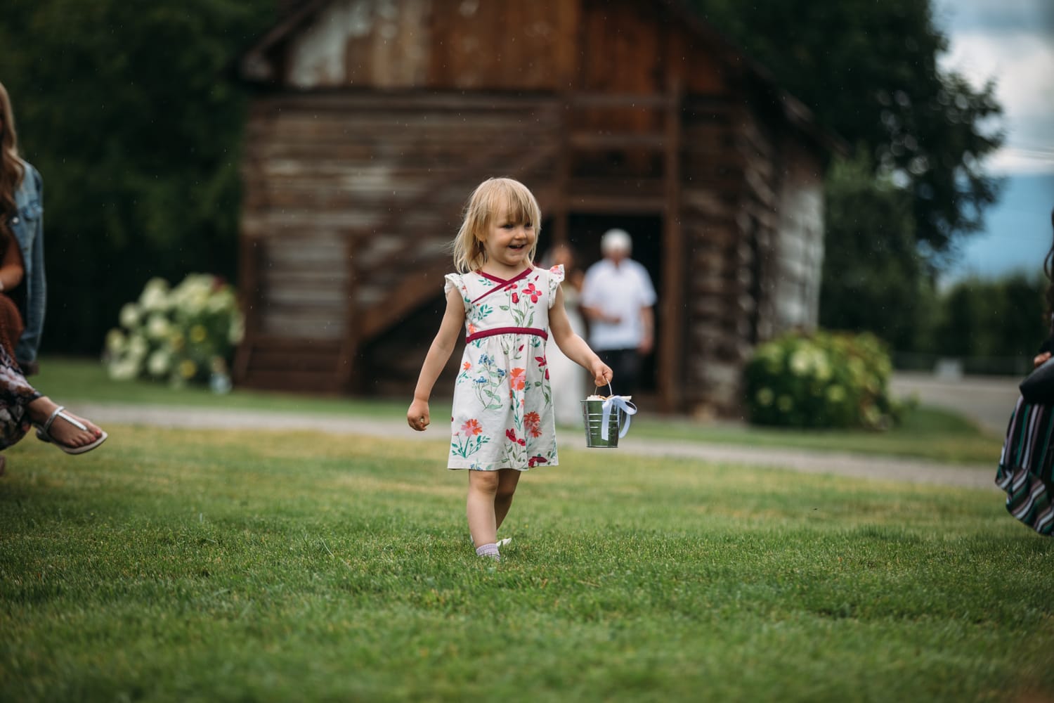 Leslie and Gerome weddings story frame 12: A Brook & Barn - Casorso Heritage Farm wedding in Kelowna, with orchard details, outbuildings, lawn games and a familiar friend-party feeling..
