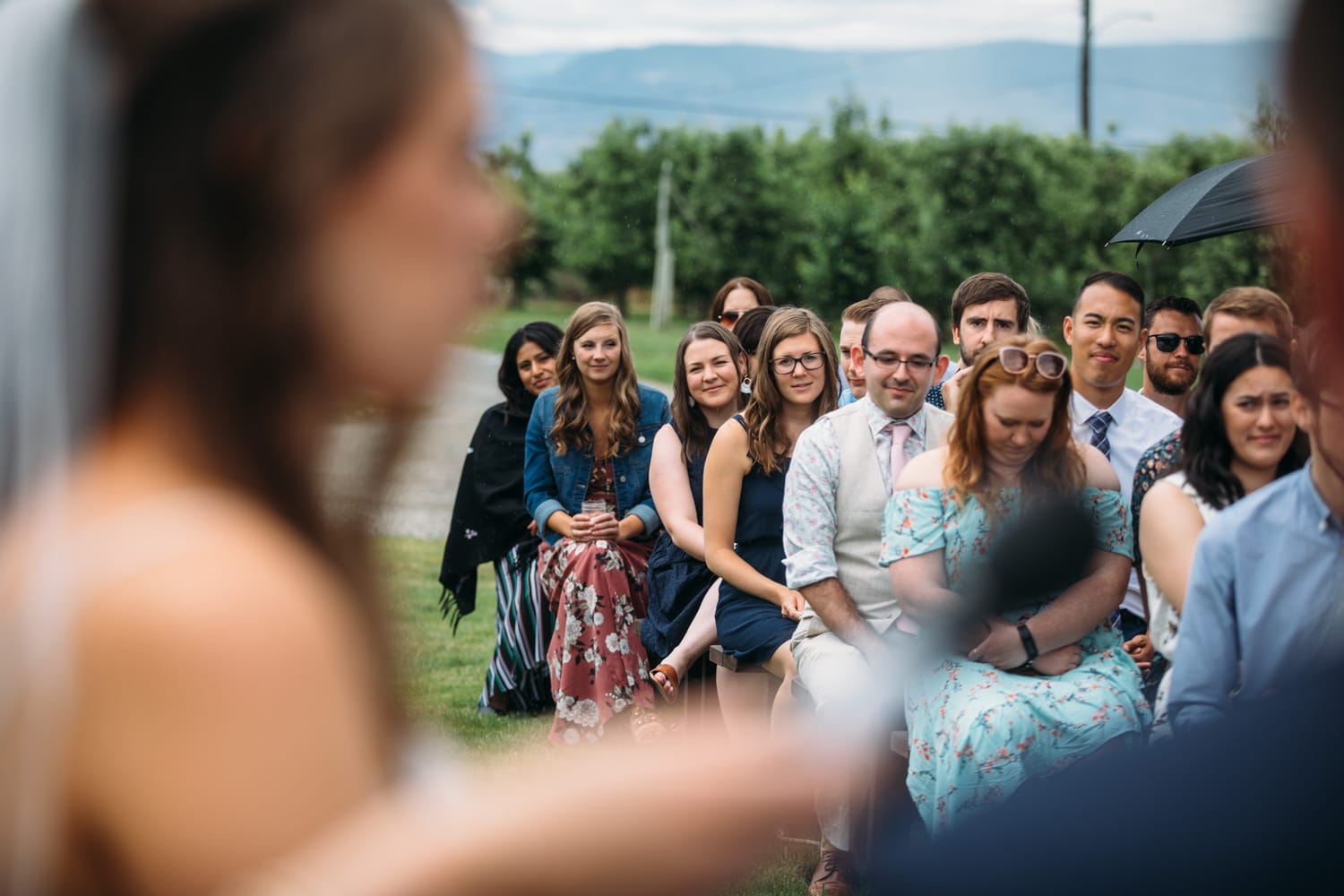 Leslie and Gerome weddings story frame 14: A Brook & Barn - Casorso Heritage Farm wedding in Kelowna, with orchard details, outbuildings, lawn games and a familiar friend-party feeling..