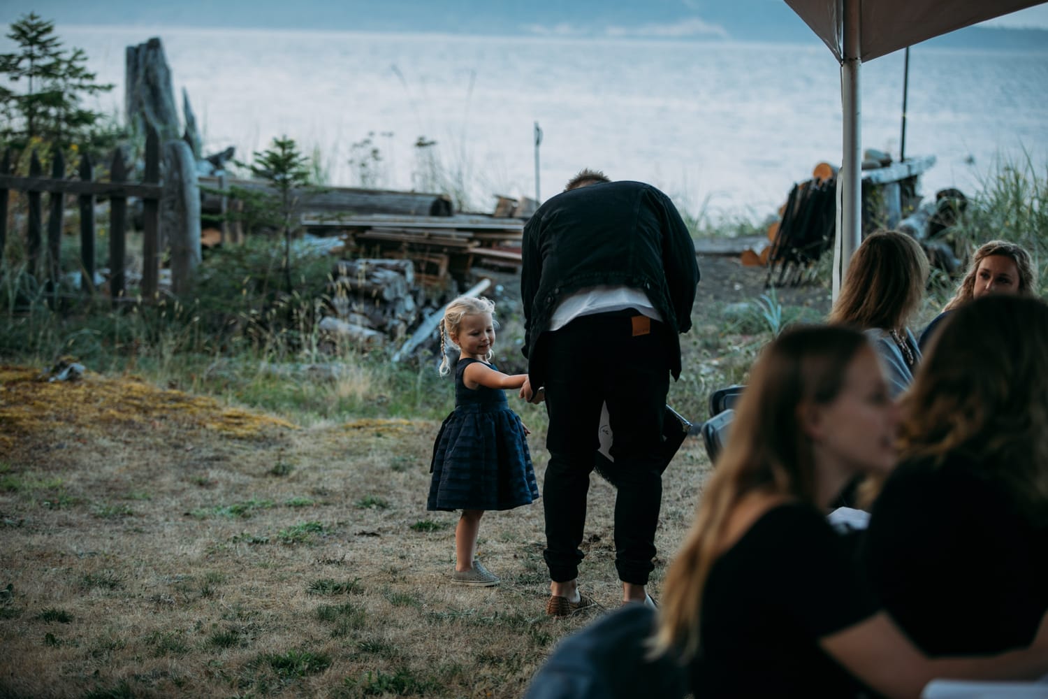Mara and Casey weddings story frame 2: A Vancouver Island private-home wedding near Qualicum Beach, with Bowser prep, Friday gathering energy, custom vendors, kids, friends and cool Island air..
