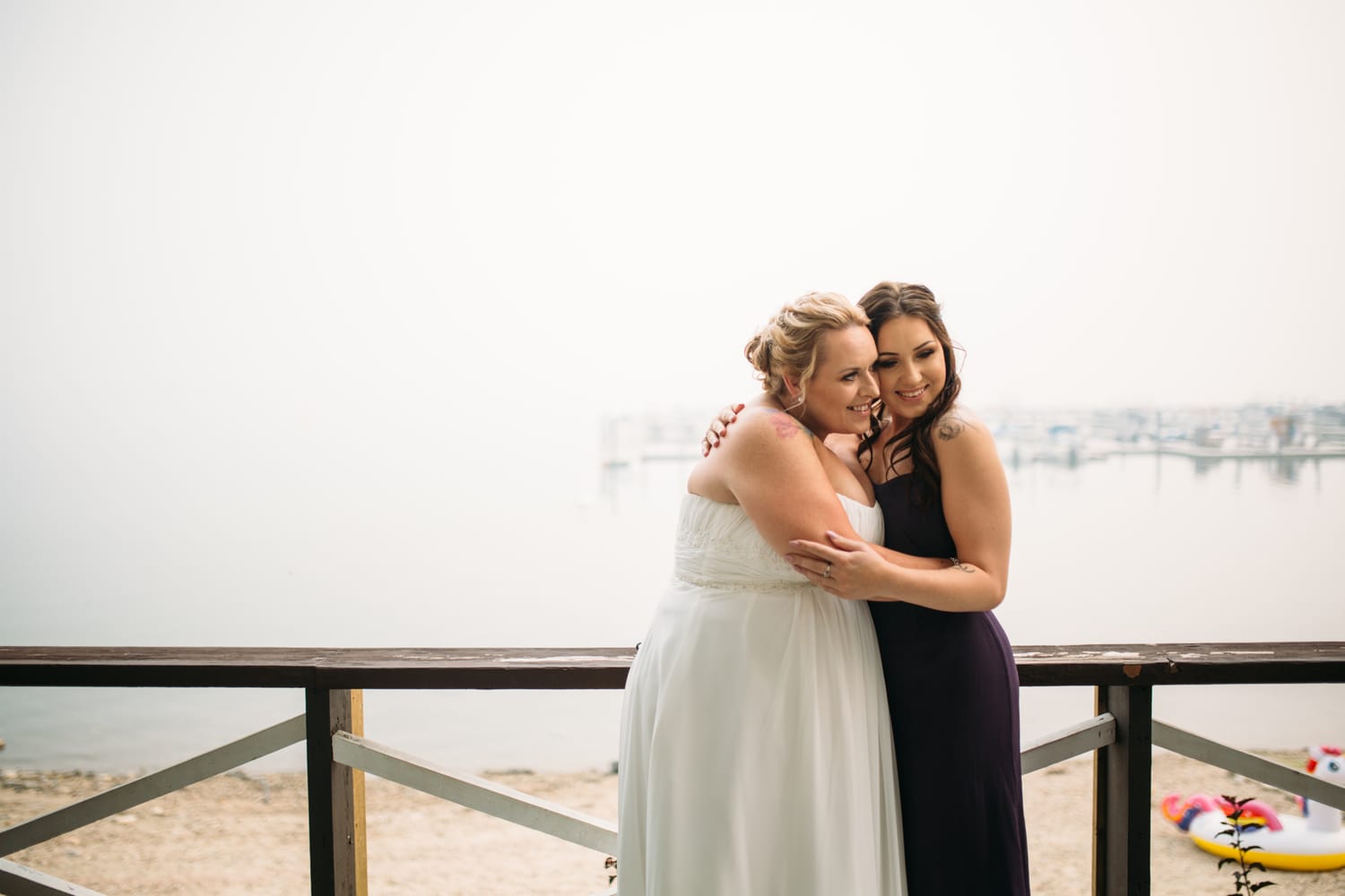 Marie and Mark weddings story frame 11: A Mabel Lake Airpark wedding in the North Okanagan, with grass-runway scenery, open-air photos and sweet family help around makeup, flowers and petals..