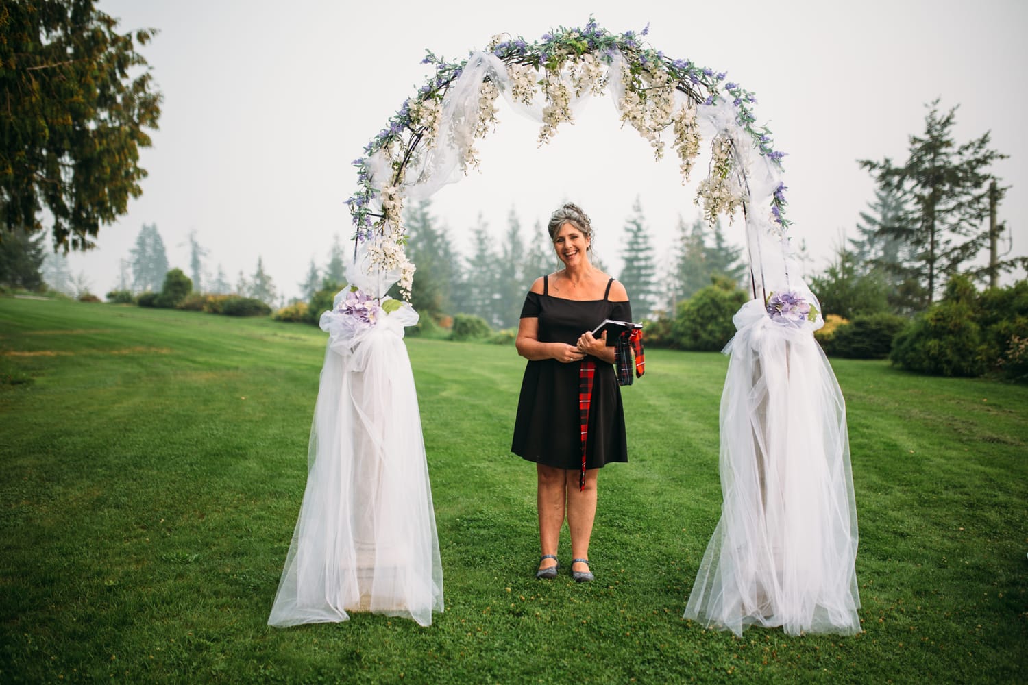 Marie and Mark weddings story frame 12: A Mabel Lake Airpark wedding in the North Okanagan, with grass-runway scenery, open-air photos and sweet family help around makeup, flowers and petals..