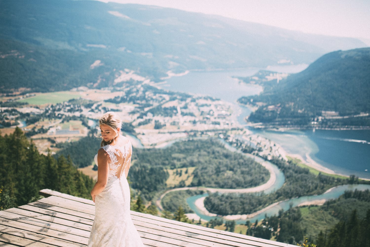 Megan and Jarid weddings story frame 11: A Shuswap-area wedding around Sicamous, Swansea Point and Hyde Mountain, with boat/lake context, cliff portraits and strong floral colour..