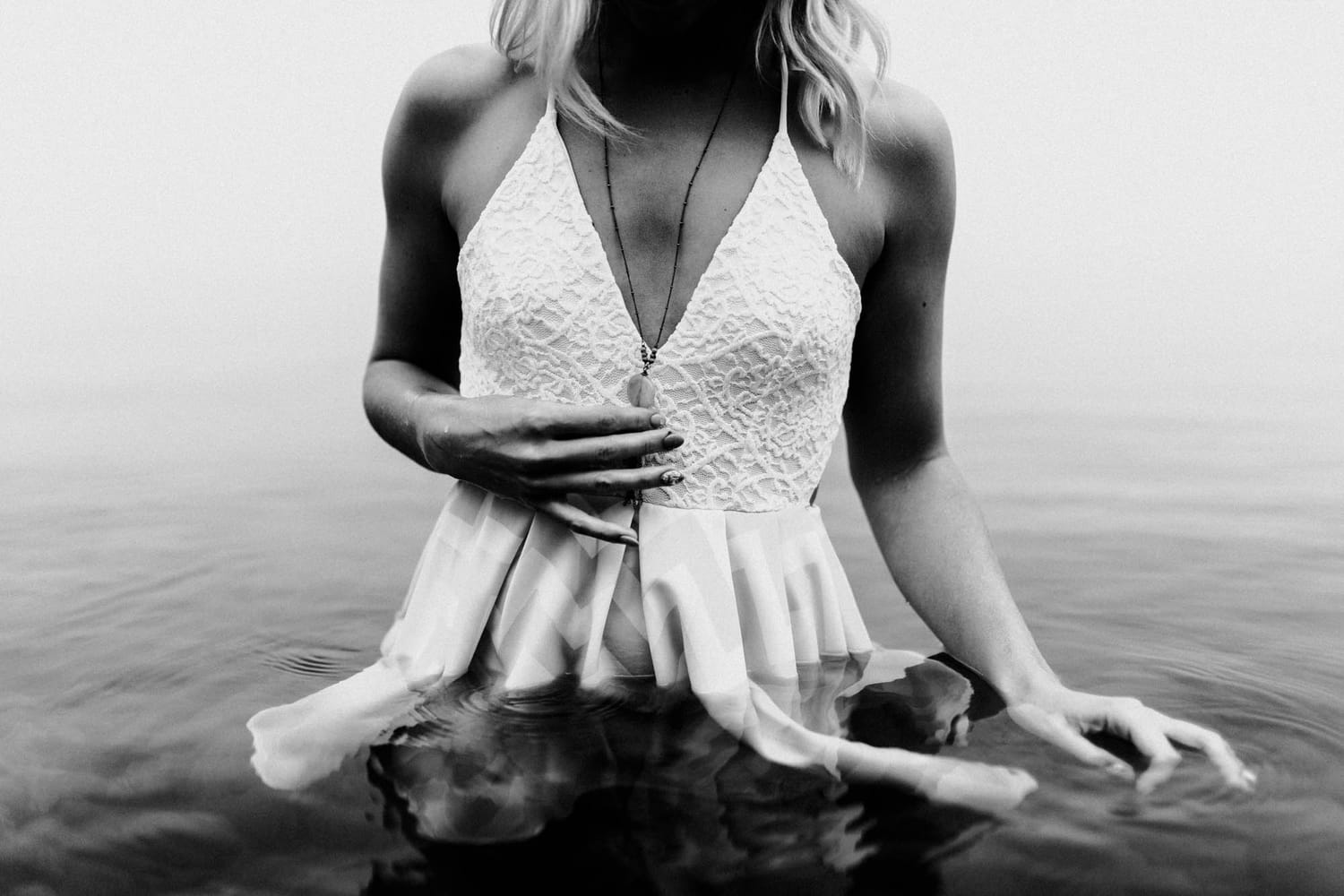 Megan Shallow portraits story frame 5: A fog-soft Kelowna lake portrait session for Megan Shallow, with water, orange dress movement, close body-language frames and quiet birds cutting through the mist.