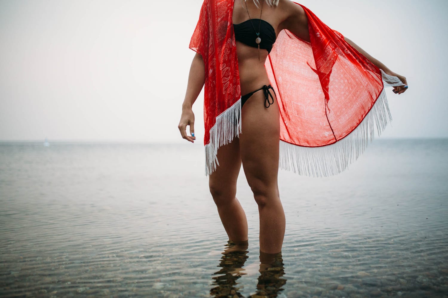 Megan Shallow portraits story frame 13: A fog-soft Kelowna lake portrait session for Megan Shallow, with water, orange dress movement, close body-language frames and quiet birds cutting through the mist.