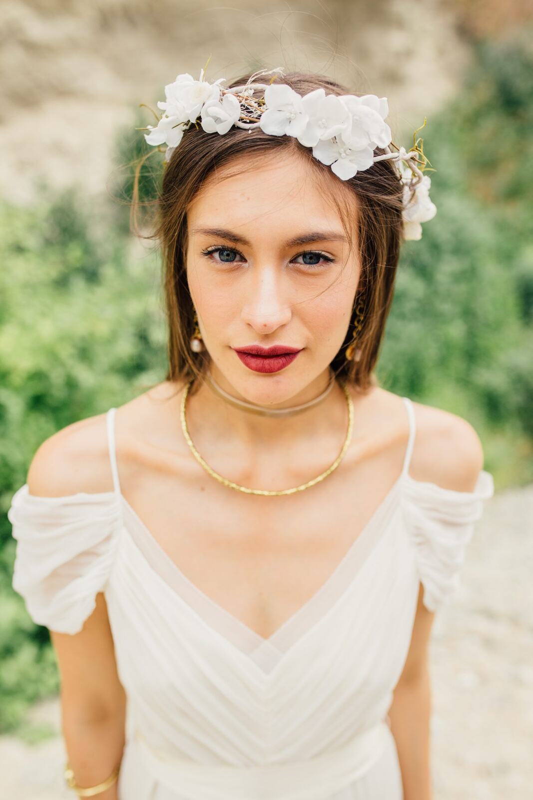 Nicole, White Willow portraits story frame 18: Nicole in a White Willow Photography-designed bridal editorial near Salmon Arm, moving from rock-face portraits through bouquet, veil and flower-crown details.
