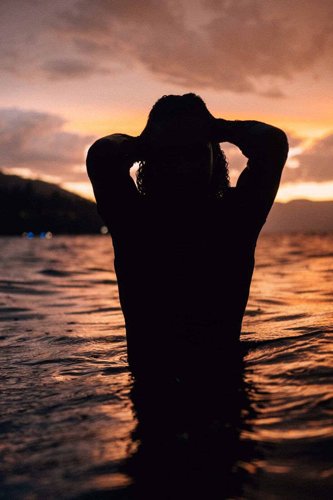 Rebekah at Bertram portraits story frame 20: A Bertram portrait story moving from floral dress and lake light into black dress, white shirt, sunset and water silhouettes.