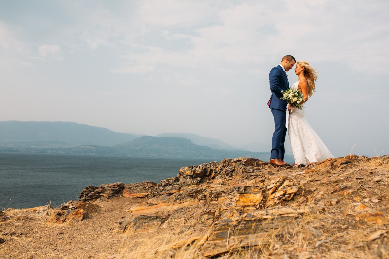 Sarah and Greg above a wide lake landscape