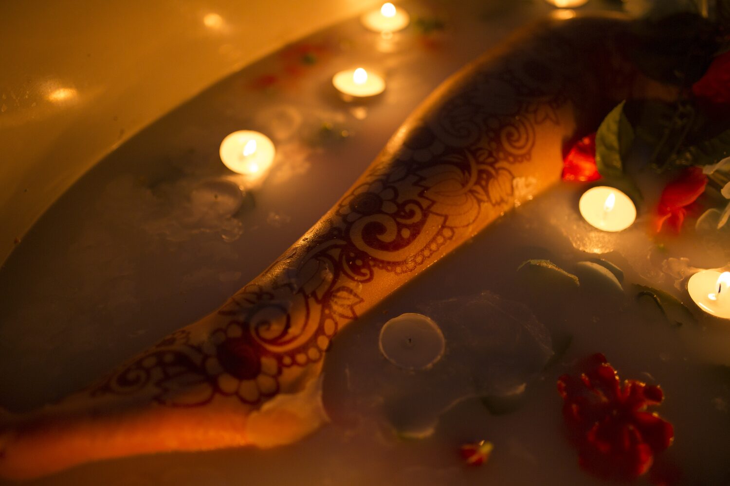Sarah: Henna, Snow and Candlelight portraits story frame 30: A four-part portrait story with Sarah in Kelowna, moving from a living-room henna session into snow, a daylight coconut-milk bath and a candlelit bath.