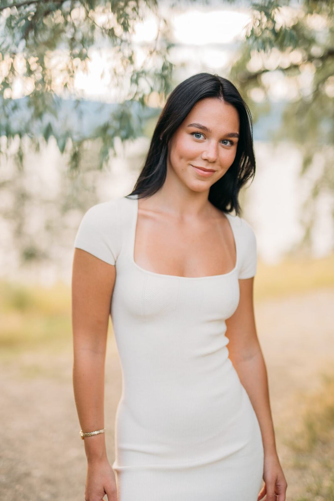 Shaylin at Bertram portraits story frame 2: A large Bertram session with water, green shade, outfit changes and Okanagan location detail that gives the story a clear place.
