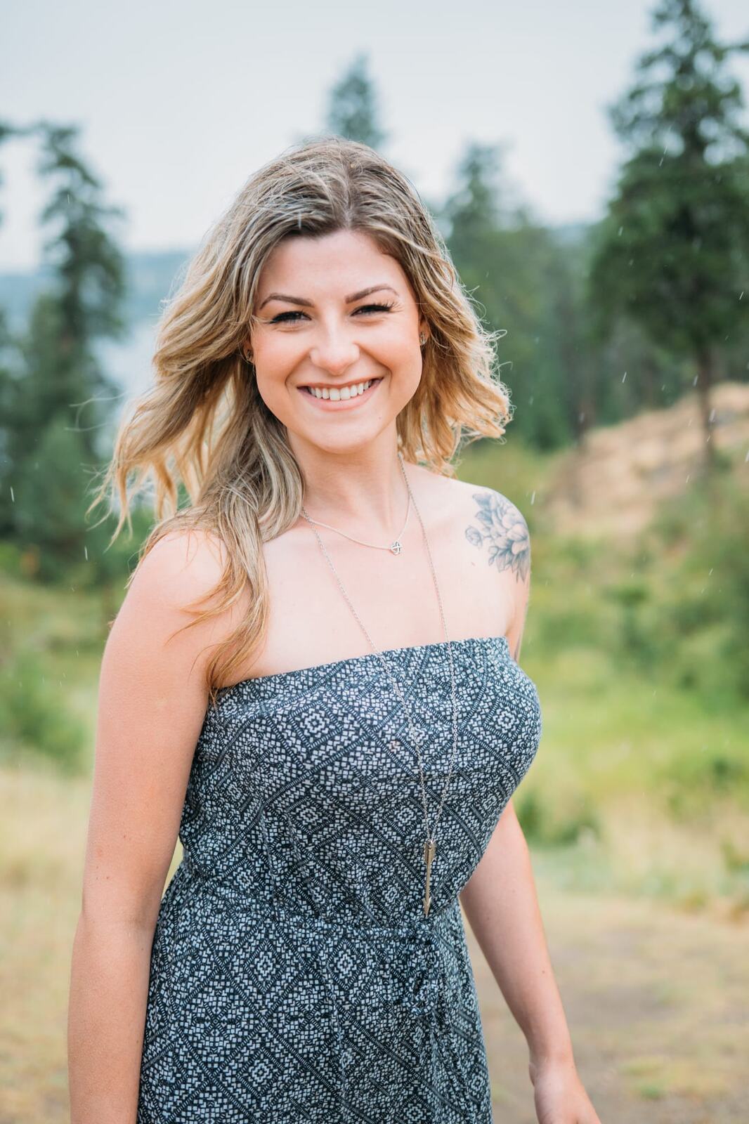 Sophia by the Lake portraits story frame 5: A multi-outfit Okanagan location session with water, trees, shoreline, denim and red swimwear woven into a summer portrait story.