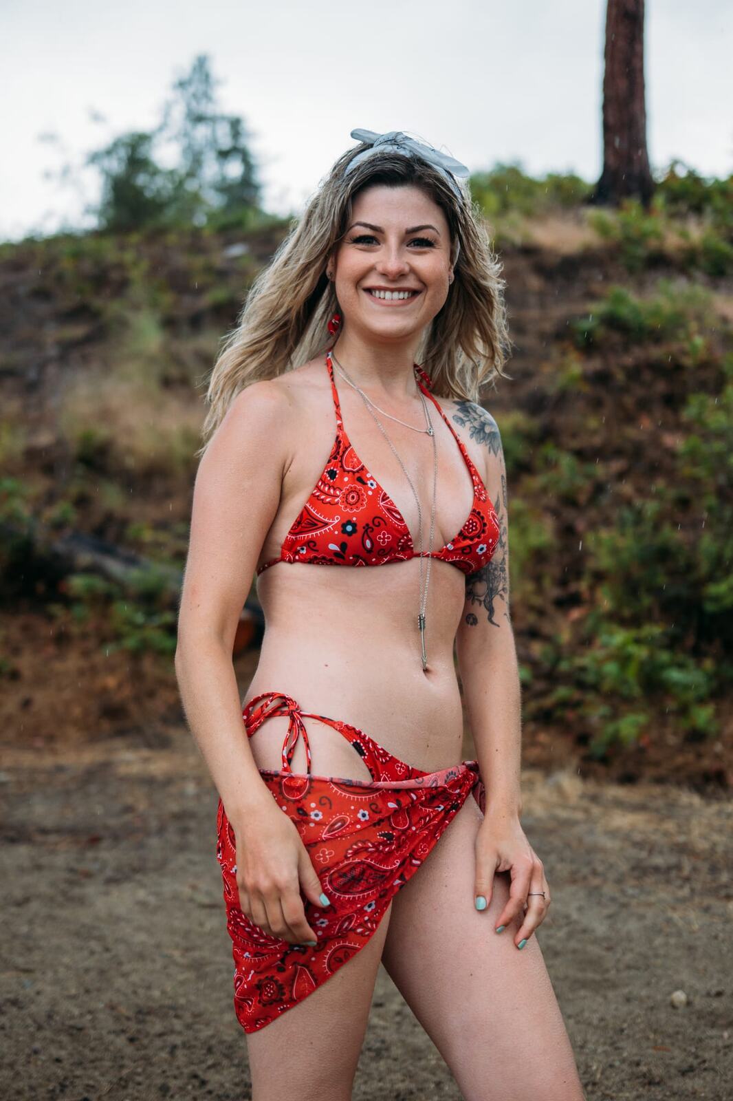Sophia by the Lake portraits story frame 24: A multi-outfit Okanagan location session with water, trees, shoreline, denim and red swimwear woven into a summer portrait story.