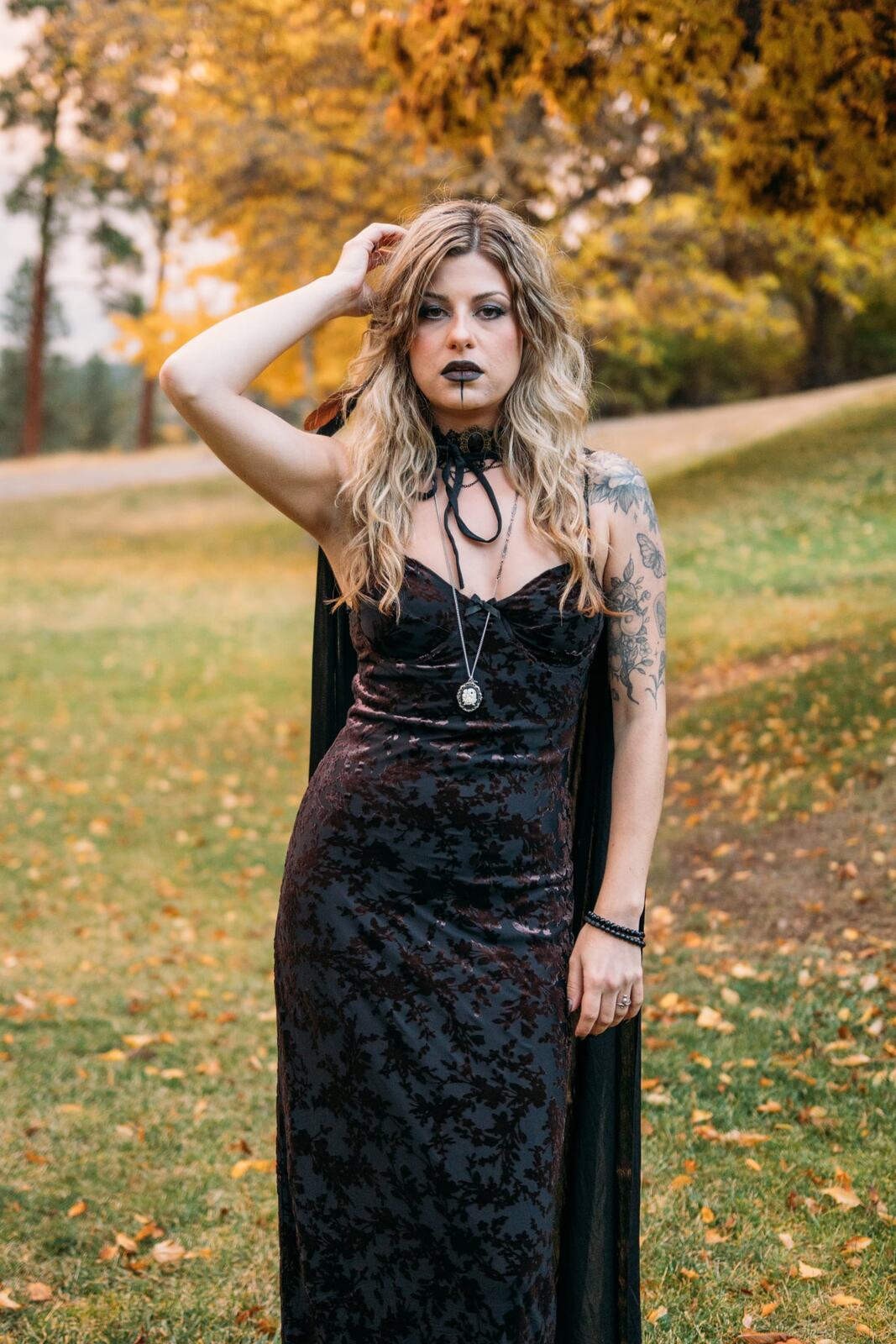 Sophia Halloween portraits story frame 2: A darker seasonal portrait story with candles, rain, rocks, and a little ritual atmosphere.