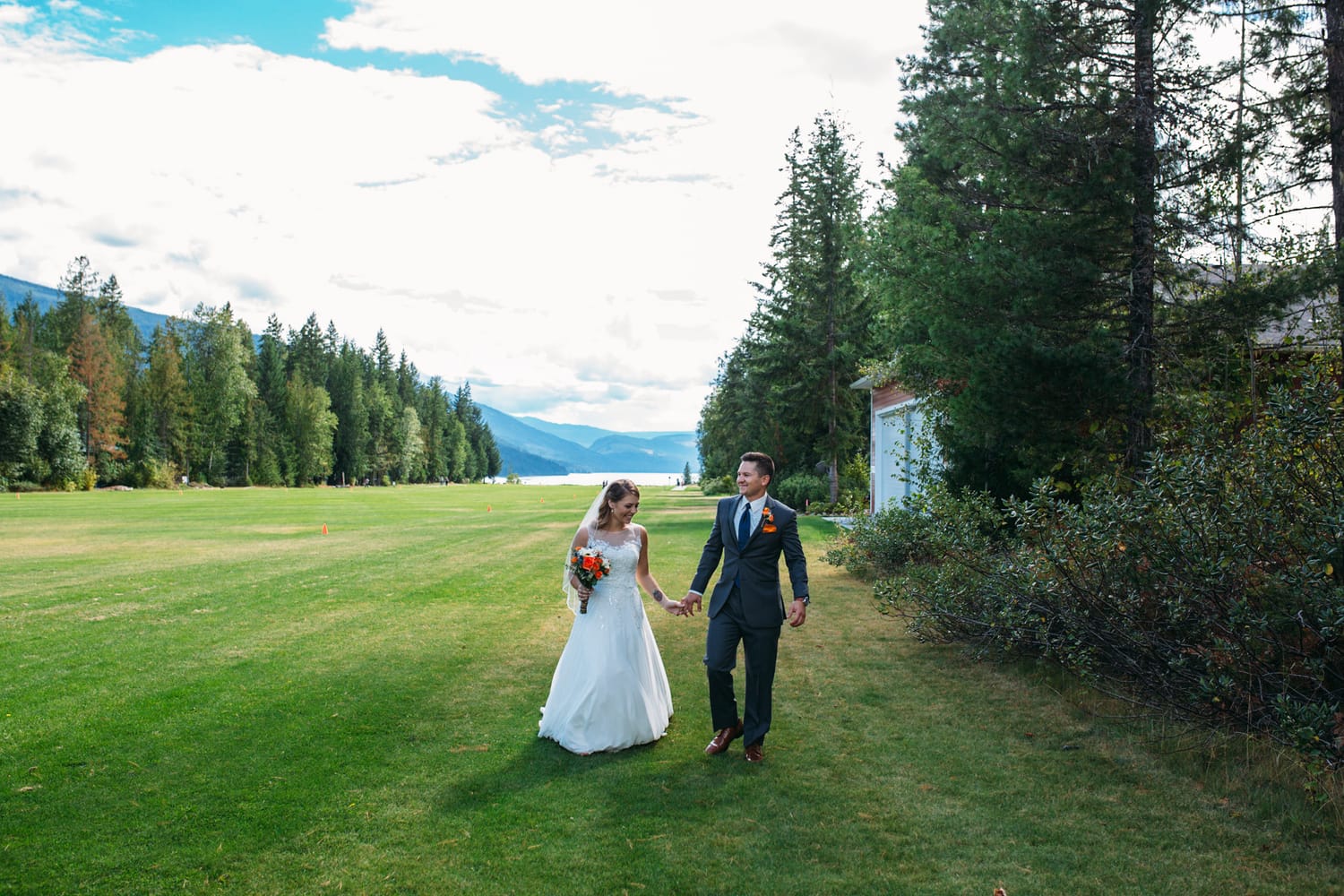 Tia and Matt weddings story frame 15: A Mabel Lake Airpark wedding in the North Okanagan, with grass-runway scenery, mountain openness and a warm end-of-night invitation..
